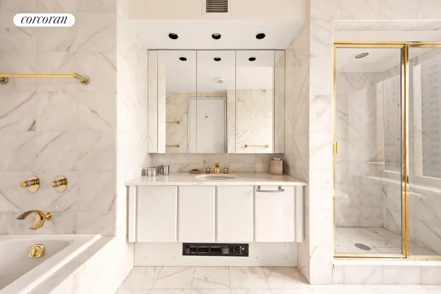 a bathroom with a bathtub sink and mirror