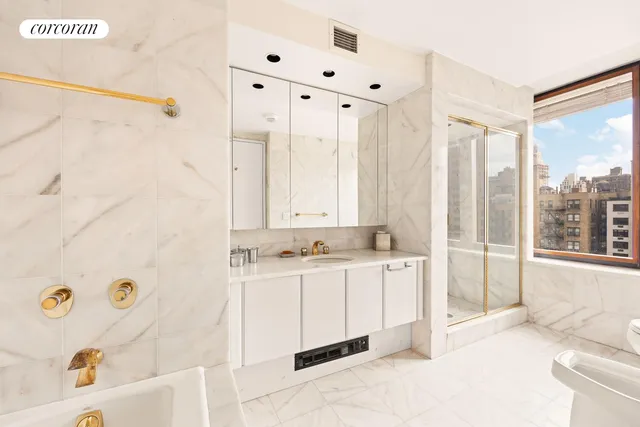 a bathroom with a tub sink and mirror