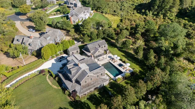 an aerial view of a house with outdoor space and a lake view