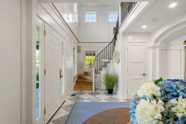 a view of entryway and hall with wooden floor