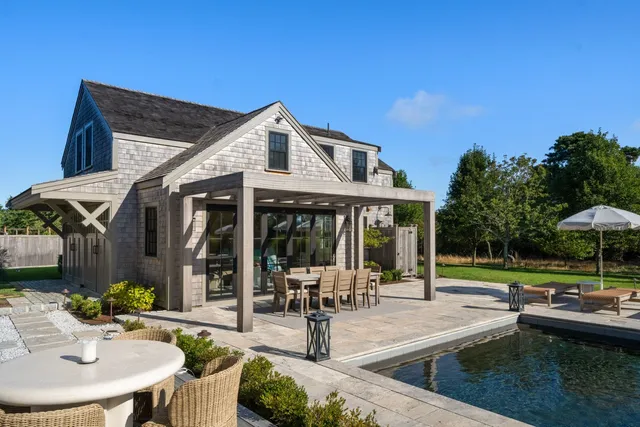 a living room with furniture and floor to ceiling windows