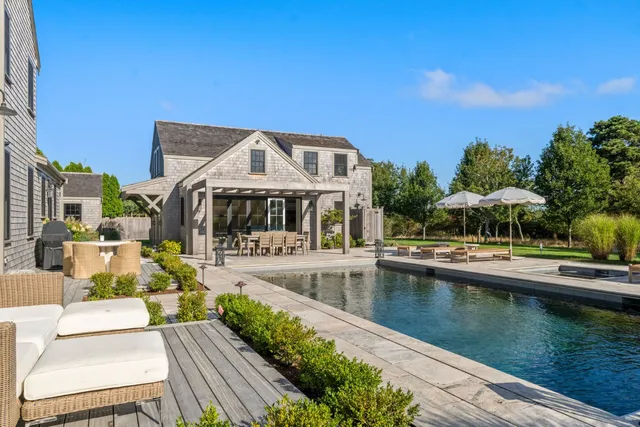 a patio with a table and chairs under an umbrella