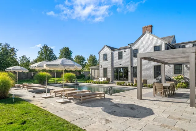 a terrace with outdoor seating and trees