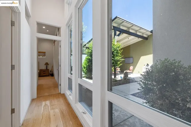 a view of a hallway view with wooden floor and living room