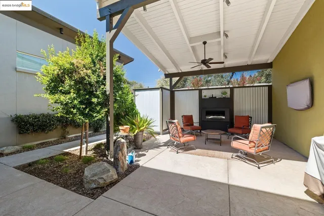 a building outdoor space with patio furniture and potted plants