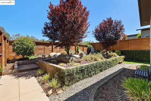 a front view of a house with garden and porch