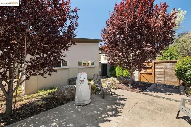 a view of a water fountain and a tree