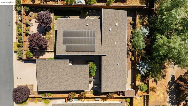 an aerial view of a house with a mountain