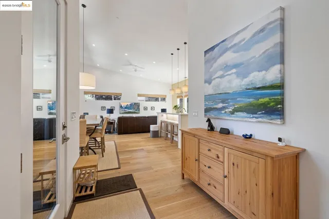 a living room with furniture a flat screen tv and a floor to ceiling window