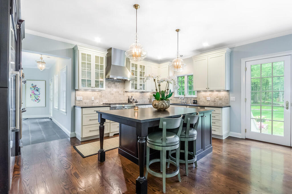 327 Middlesex Road Darien, CT 06820 - Photo 13 of 40 a dining hall with stainless steel appliances kitchen island granite countertop furniture and a wooden floor