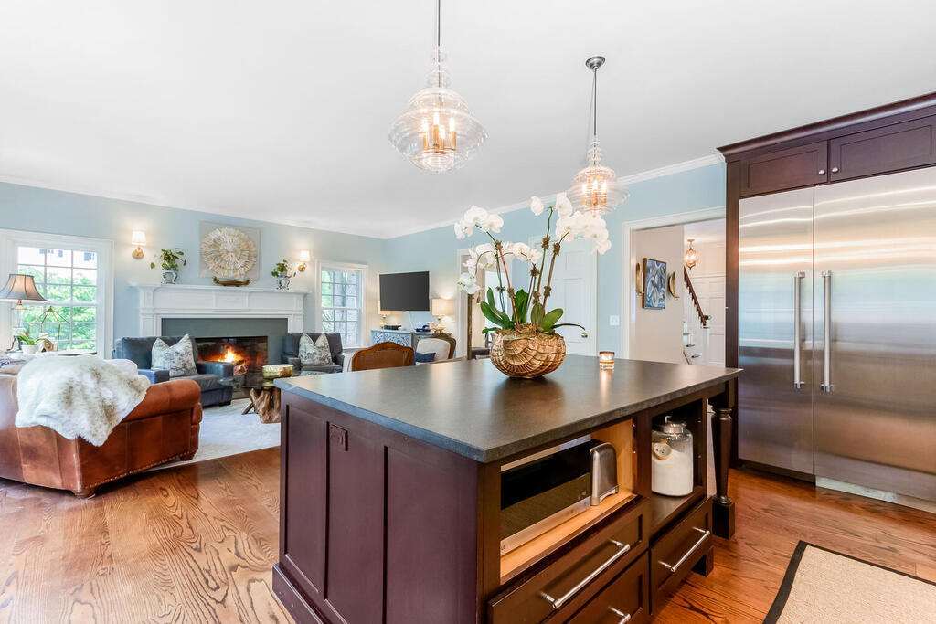 327 Middlesex Road Darien, CT 06820 - Photo 16 of 40 a living room with dining table furniture a fireplace and a chandelier