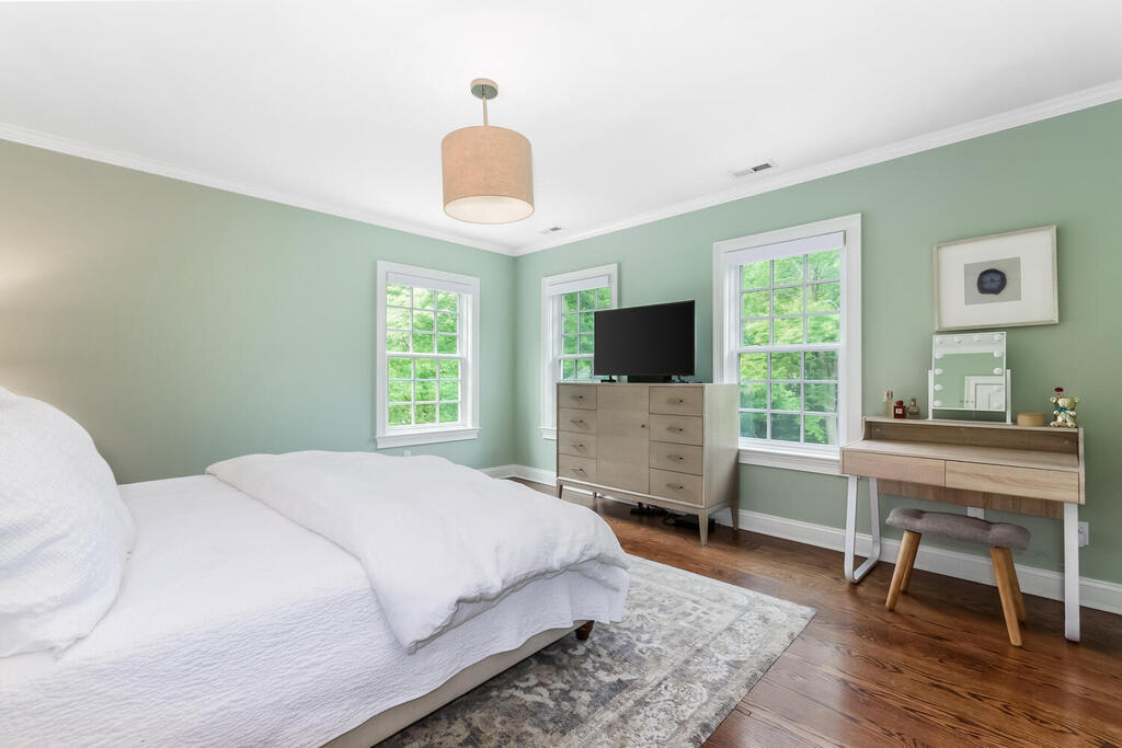 327 Middlesex Road Darien, CT 06820 - Photo 19 of 40 a spacious bedroom with a bed and a flat screen tv