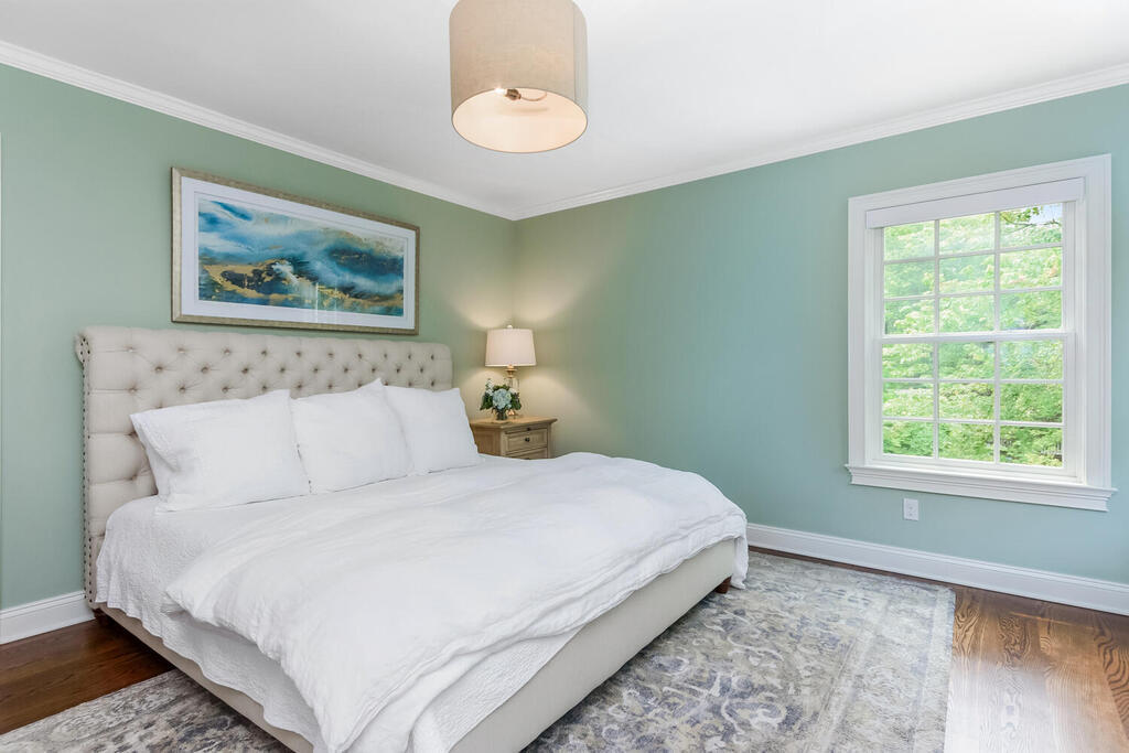 327 Middlesex Road Darien, CT 06820 - Photo 20 of 40 a bedroom with a bed and a painting on the wall