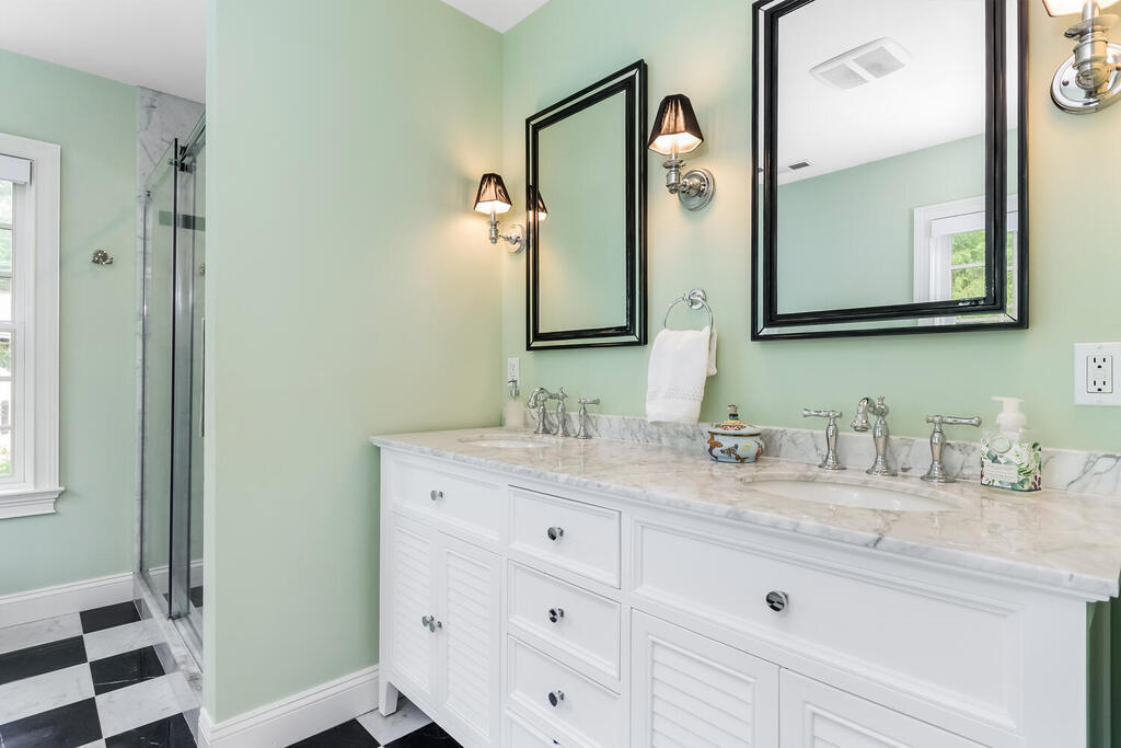 327 Middlesex Road Darien, CT 06820 - Photo 22 of 40 a bathroom with a granite countertop sink vanity and mirror