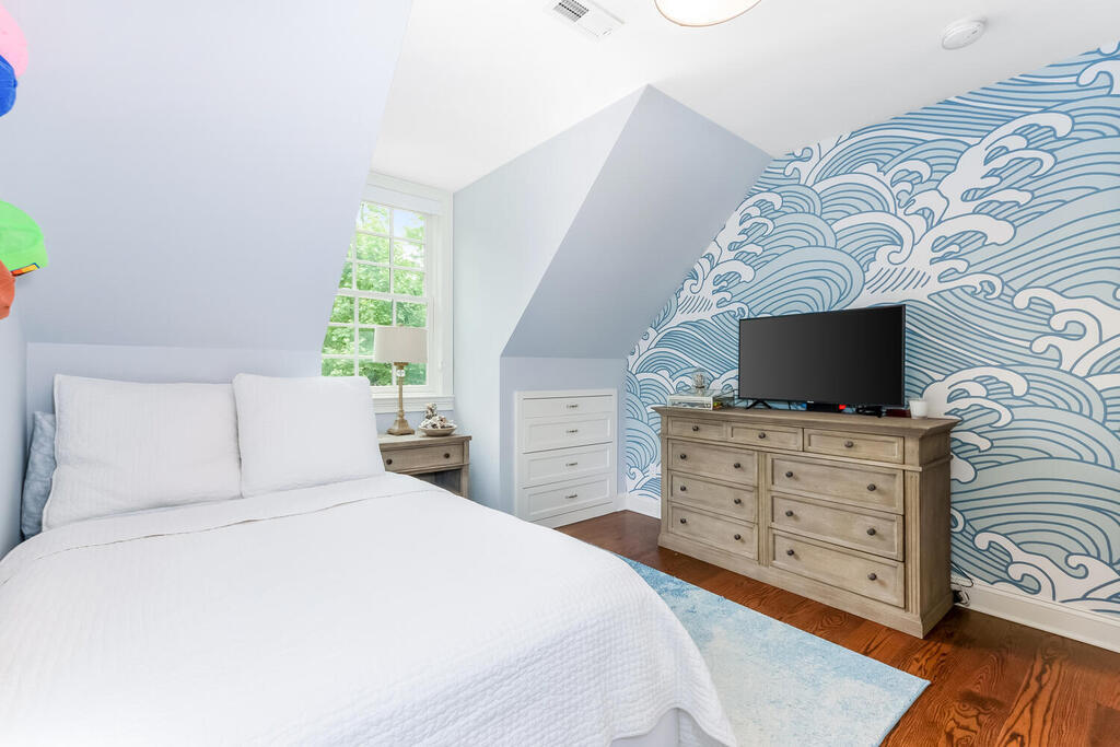 327 Middlesex Road Darien, CT 06820 - Photo 24 of 40 a bedroom with a bed and a flat screen tv
