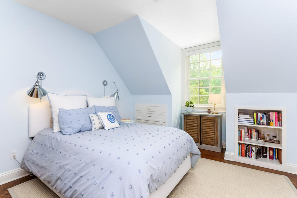 327 Middlesex Road Darien, CT 06820 - Photo 27 of 40 a bedroom with a large bed and a book shelf