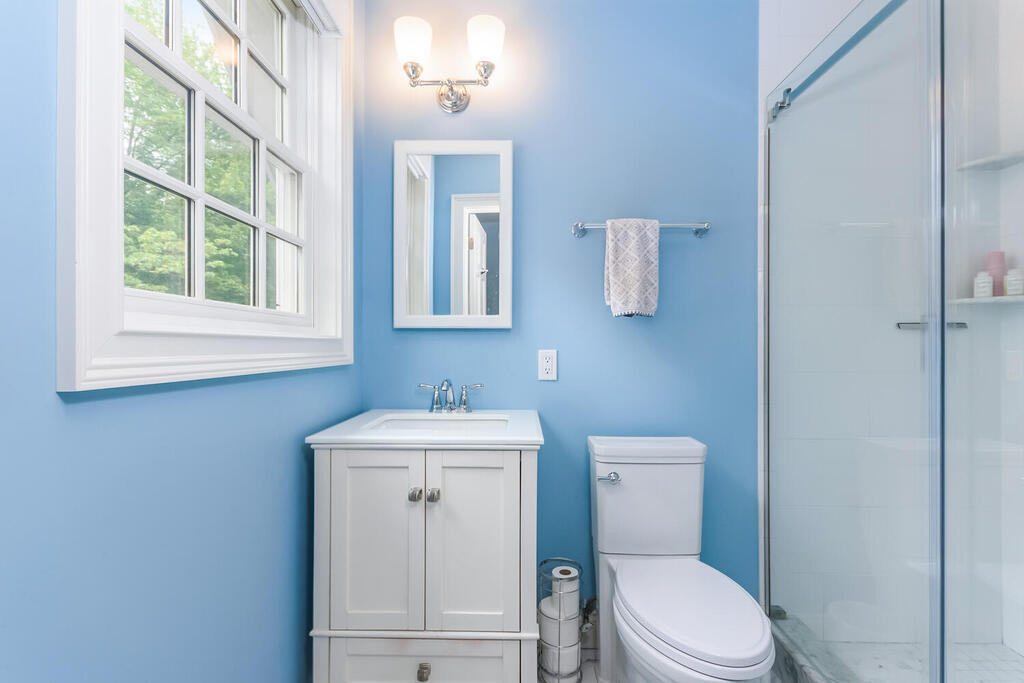 327 Middlesex Road Darien, CT 06820 - Photo 28 of 40 a bathroom with a toilet a sink a vanity and mirror