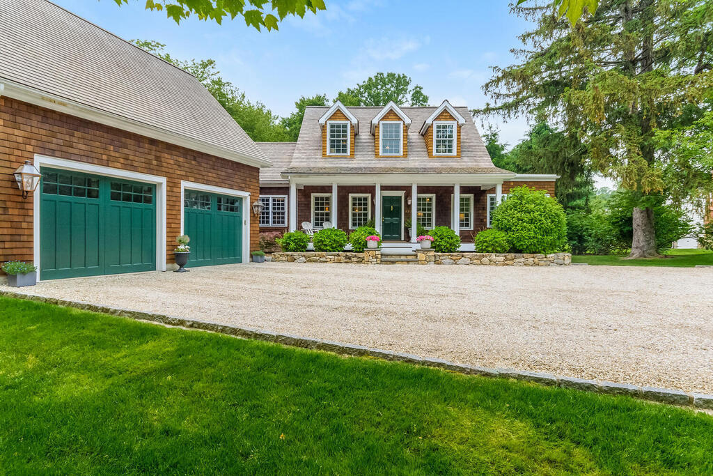 327 Middlesex Road Darien, CT 06820 - Photo 3 of 40 a front view of a house with a yard and potted plants