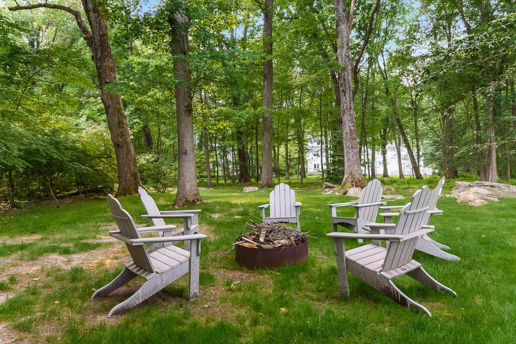 327 Middlesex Road Darien, CT 06820 - Photo 34 of 40 a view of a chairs and backyard with large trees