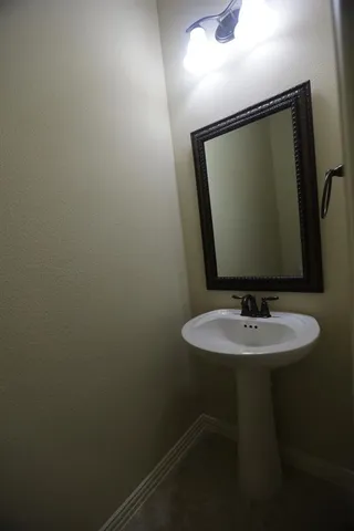 a bathroom with a sink and mirror