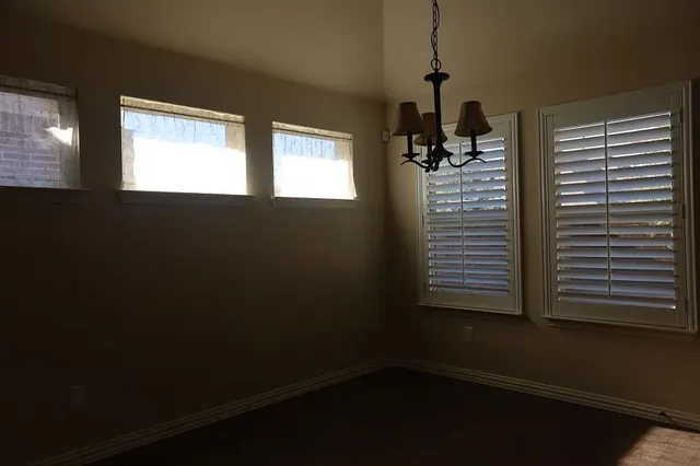 a view of a room with two windows