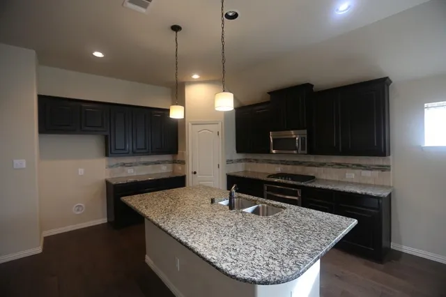 a bathroom with a tub sink and mirror
