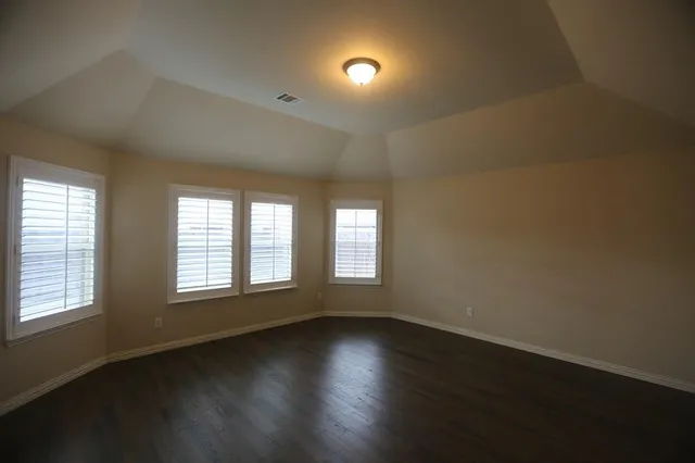 a bathroom with a granite countertop bathtub shower sink vanity and toilet
