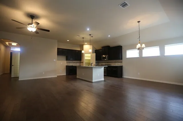 a view of kitchen with stove and refrigerator