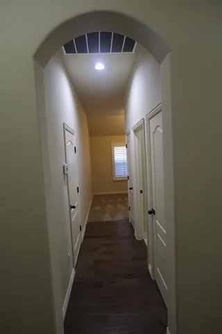 a view of a hallway with wooden floor