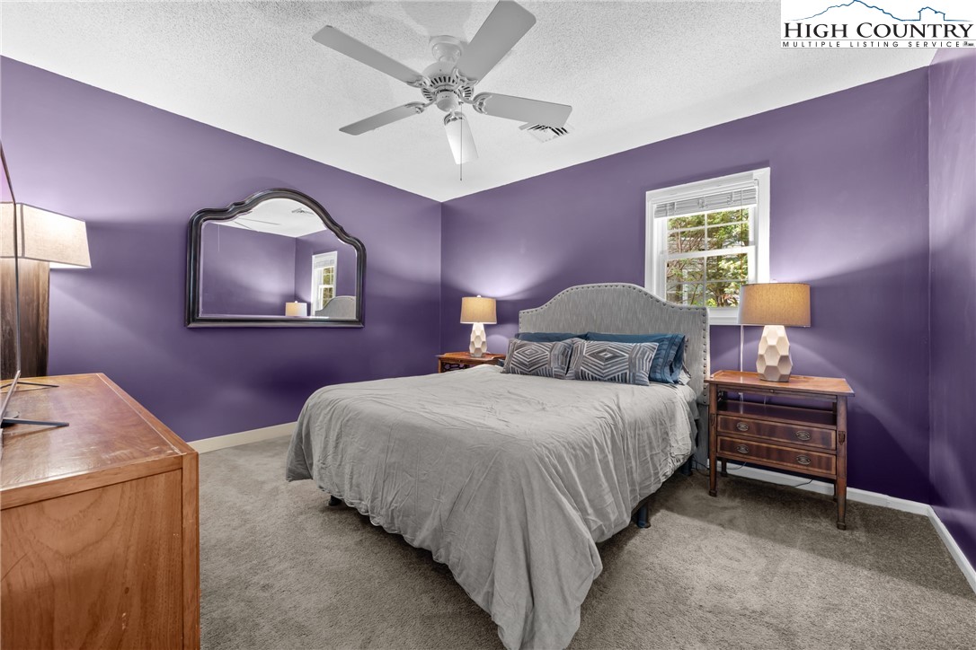 17 Elderberry Loop Newland, NC 28657 - Photo 19 of 47 a bedroom with a bed and a chandelier