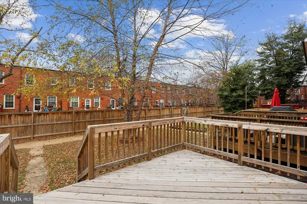 a kitchen with granite countertop a stove top oven a sink dishwasher a microwave oven with cabinets and wooden floor