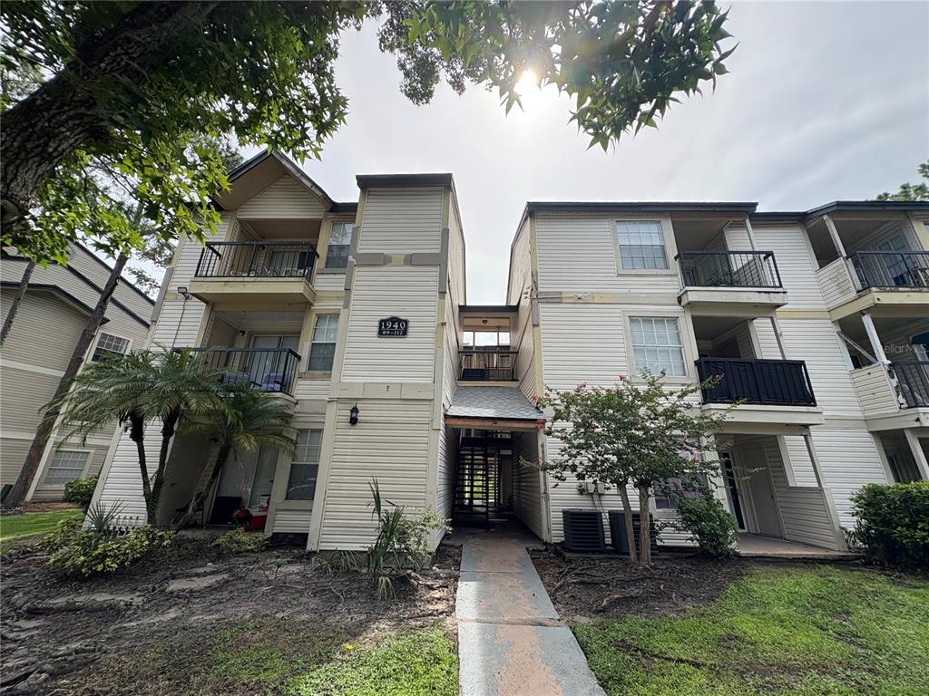 1940 Lake Atriums Circle, Unit 101 Orlando, FL 32839 - Photo 11 of 14 a front view of a house with a yard