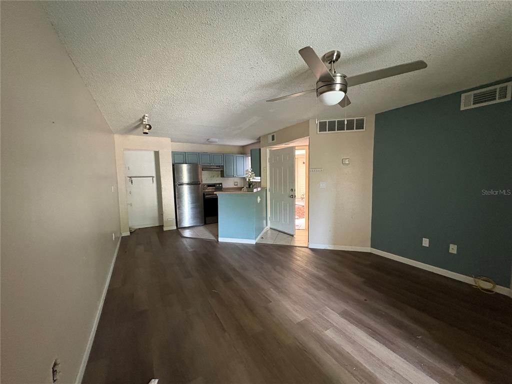1940 Lake Atriums Circle, Unit 101 Orlando, FL 32839 - Photo 3 of 14 a view of empty room with wooden floor and ceiling fan