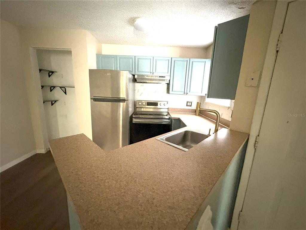 1940 Lake Atriums Circle, Unit 101 Orlando, FL 32839 - Photo 7 of 14 a kitchen with refrigerator and window