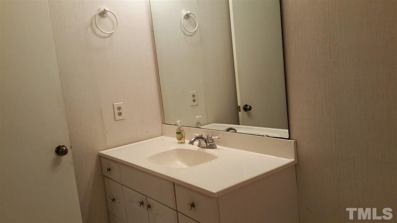637 Pine Ridge Place, Unit 637 Raleigh, NC 27609 - Photo 11 of 14 a bathroom with a sink and mirror with shower