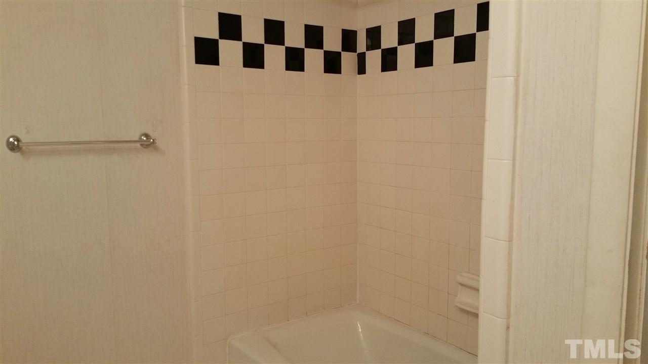 637 Pine Ridge Place, Unit 637 Raleigh, NC 27609 - Photo 12 of 14 a bathroom with a shower