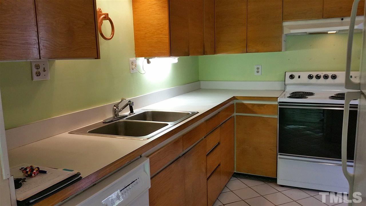 637 Pine Ridge Place, Unit 637 Raleigh, NC 27609 - Photo 4 of 14 a kitchen with a sink and a stove top oven