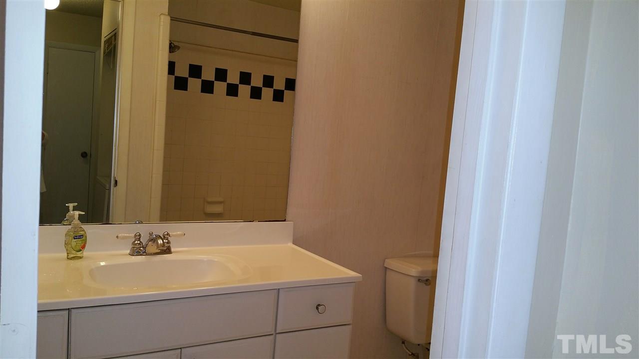 637 Pine Ridge Place, Unit 637 Raleigh, NC 27609 - Photo 10 of 14 a bathroom with a sink a toilet and shower