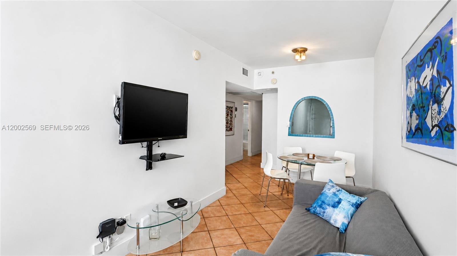 100 Lincoln Road, Unit 1209 Miami Beach, FL 33139 - Photo 2 of 25 a living room with furniture and a flat screen tv