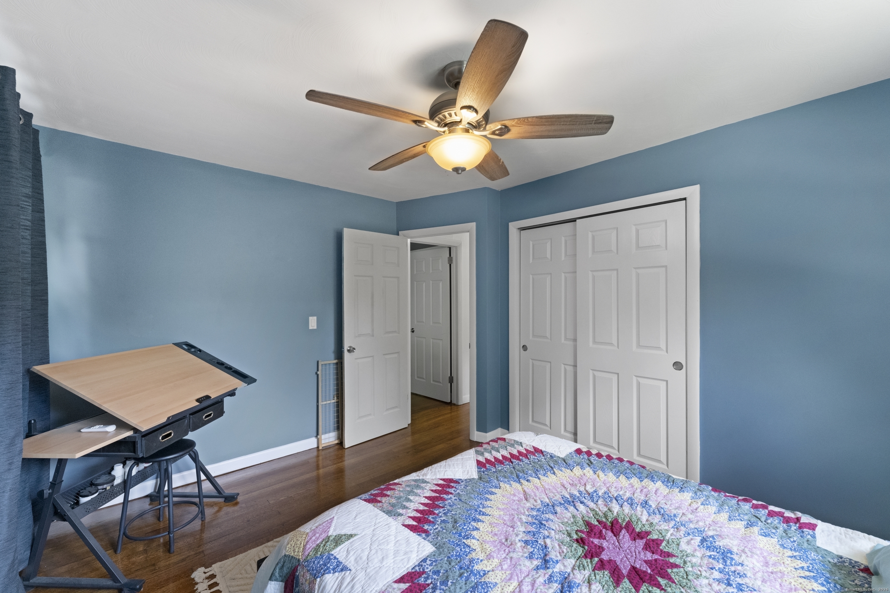 11 Willow Lane Ledyard, CT 06339 - Photo 20 of 39 a bedroom with a bed and a chandelier