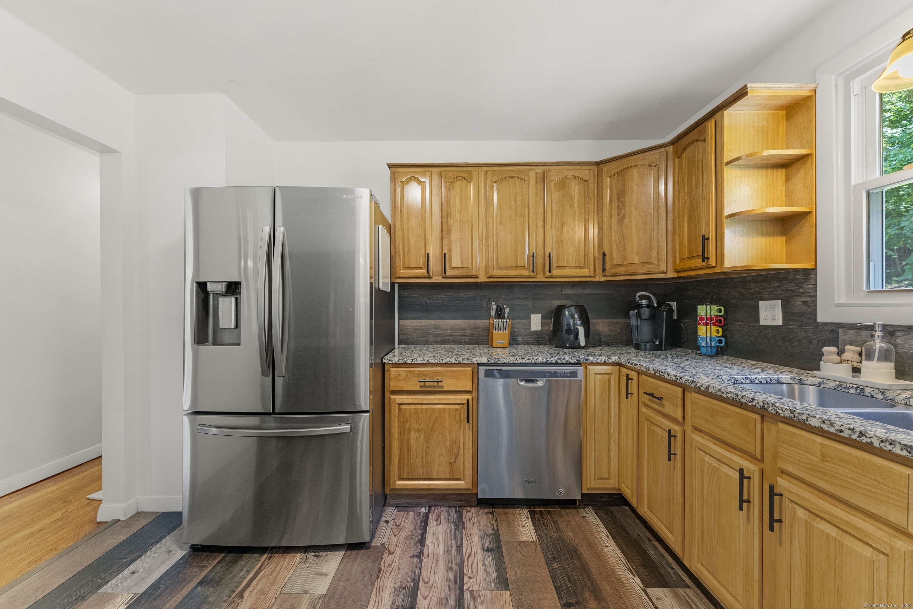 11 Willow Lane Ledyard, CT 06339 - Photo 4 of 39 a kitchen with stainless steel appliances granite countertop a refrigerator a sink dishwasher a stove and white countertops with wooden floor