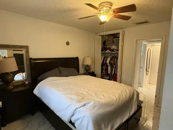 a bedroom with a bed and a chandelier