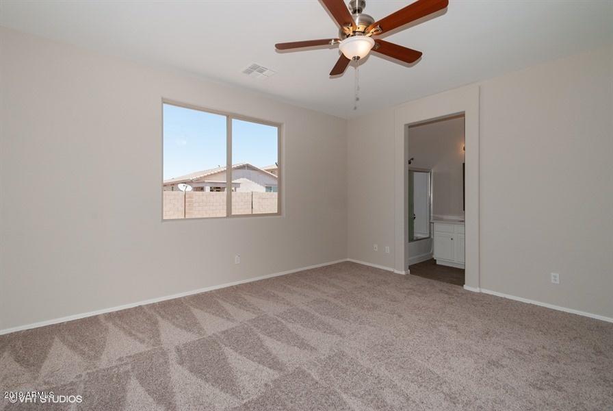 7338 West Darrel Road Laveen, AZ 85339 - Photo 17 of 25 an empty room with windows and fan