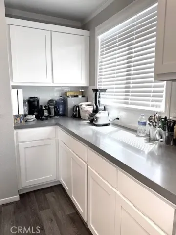 a kitchen with a sink a window and cabinets