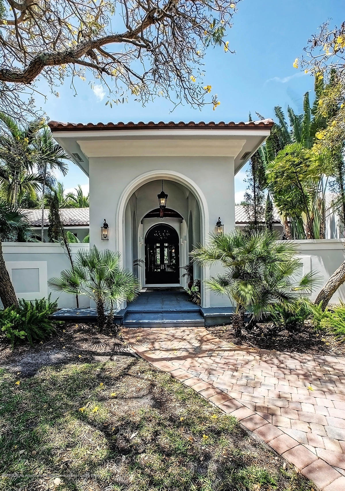 2570 Hampton Bridge Road Delray Beach, FL 33445 - Photo 2 of 40 a front view of a house with garden
