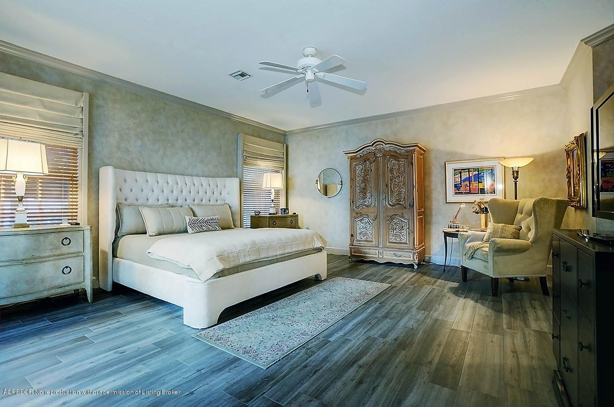 2570 Hampton Bridge Road Delray Beach, FL 33445 - Photo 20 of 40 a bedroom with a bed and a chandelier