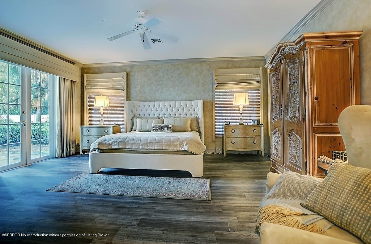 2570 Hampton Bridge Road Delray Beach, FL 33445 - Photo 21 of 40 a spacious bedroom with a bed a couch and a window