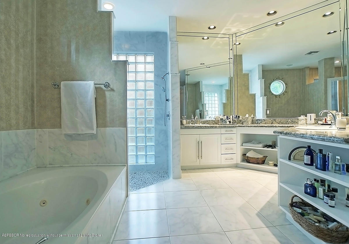 2570 Hampton Bridge Road Delray Beach, FL 33445 - Photo 22 of 40 a bathroom with a tub a sink and a shower