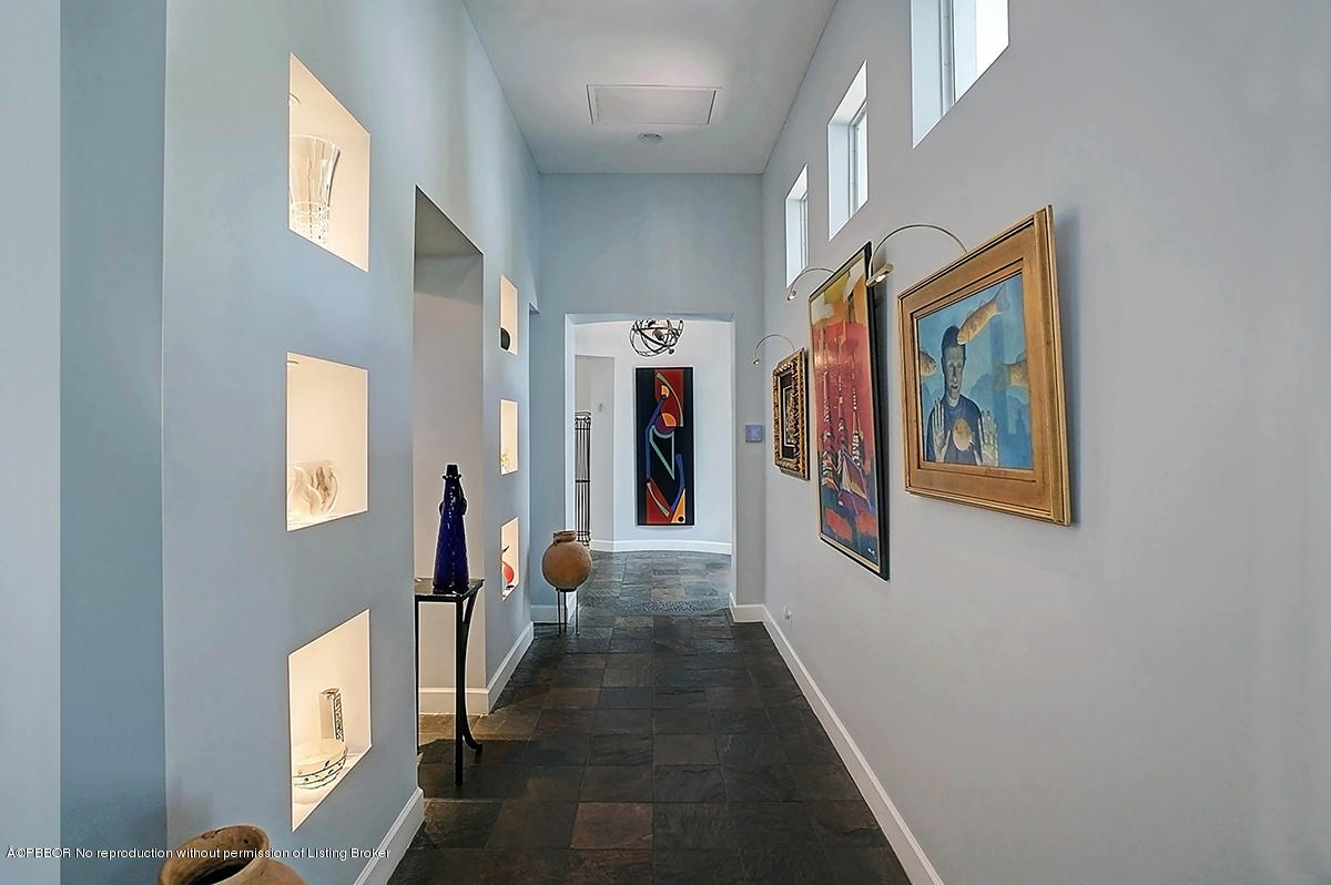 2570 Hampton Bridge Road Delray Beach, FL 33445 - Photo 4 of 40 a hallway with wooden floor and windows