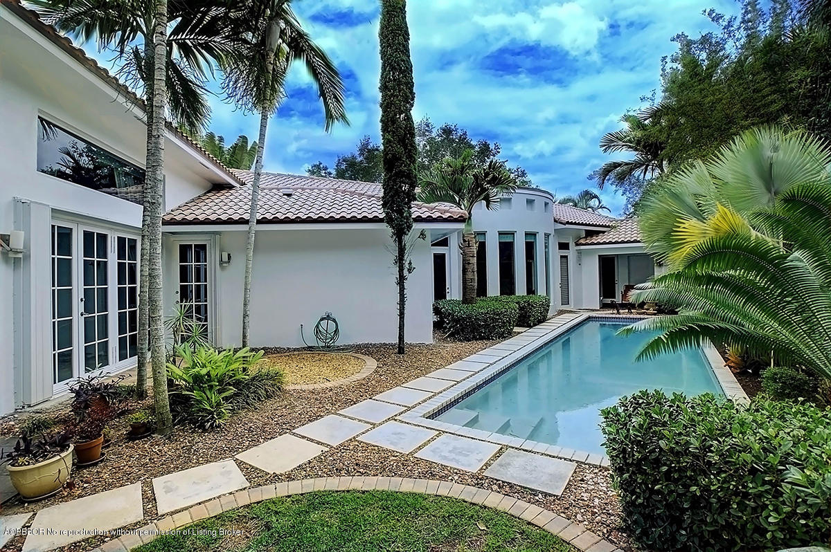 2570 Hampton Bridge Road Delray Beach, FL 33445 - Photo 34 of 40 a front view of house with yard and green space